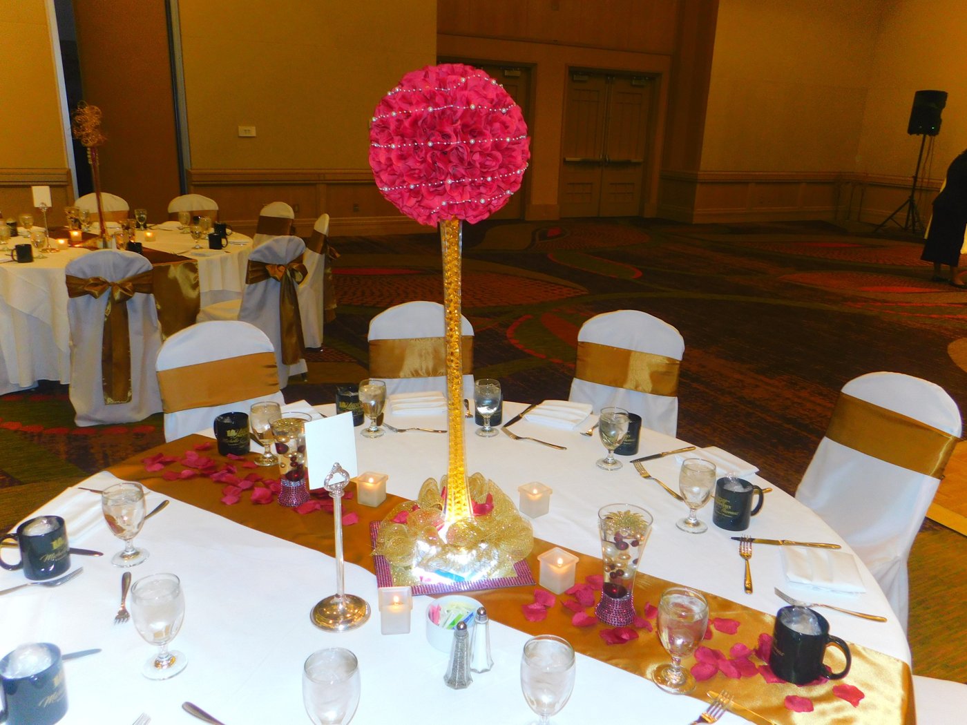 Red topiary centerpiece in ballroom